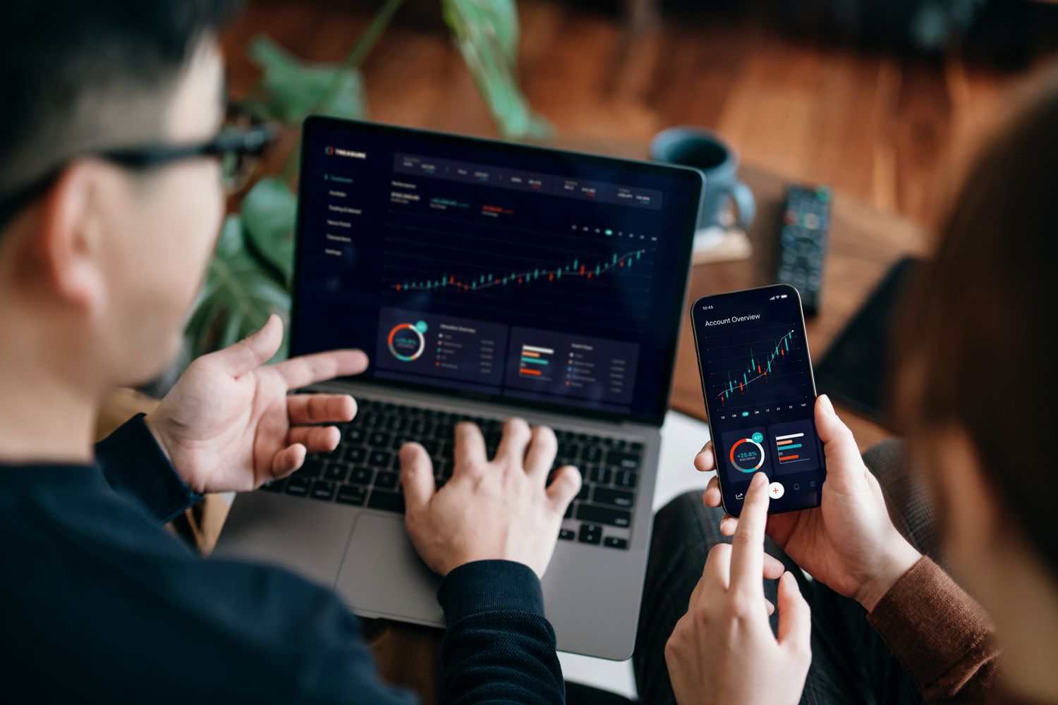 Diverse group of professionals discussing cryptocurrency investment options on a laptop for 401(k) retirement planning