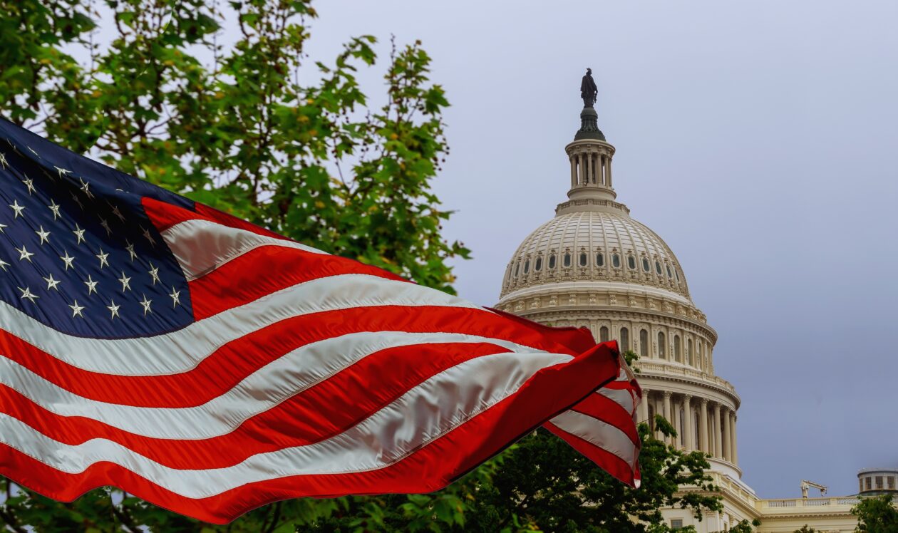 Capitol Hill with American flag representing new US crypto legislation for 401(k) retirement plans